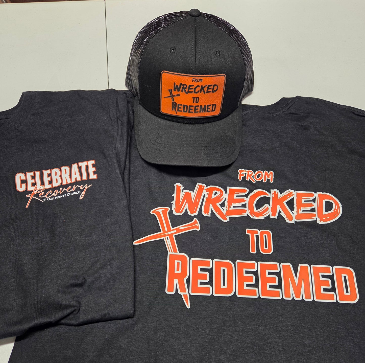 From Wrecked to Redeemed Black Yupoong hat with Orange laser engraved patch